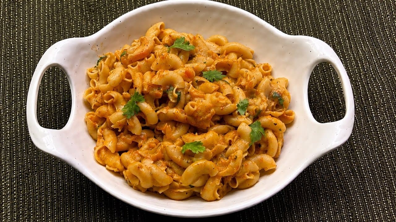 Plate of spaghetti with tomato sauce, basil, and parmesan